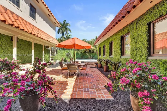 a view of a house with sitting area and garden