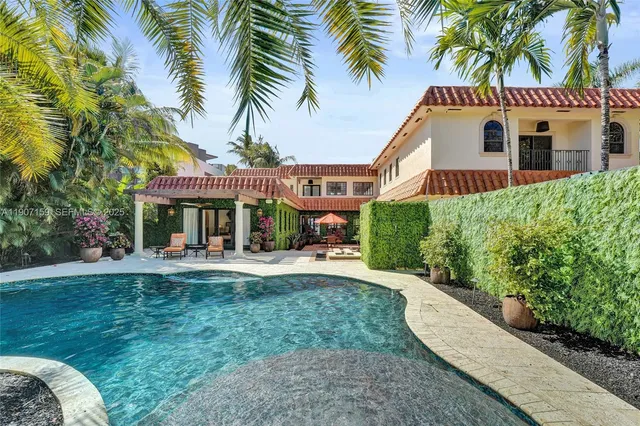 a view of a house with swimming pool and sitting area