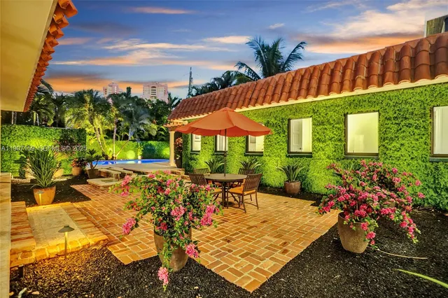 a living room with furniture a fireplace and a chandelier