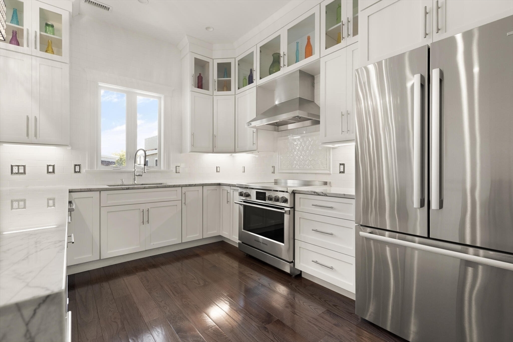 125 Heath Street Somerville, MA 02145 - Photo 16 of 42 a kitchen with stainless steel appliances a refrigerator sink and cabinets
