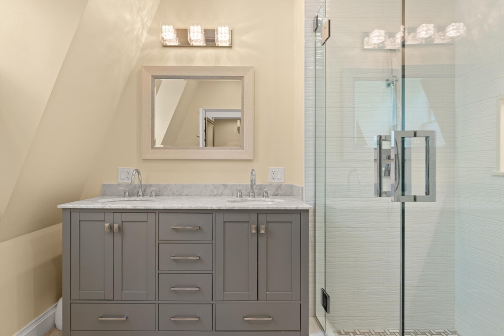 125 Heath Street Somerville, MA 02145 - Photo 23 of 42 a bathroom with a granite countertop sink vanity and mirror