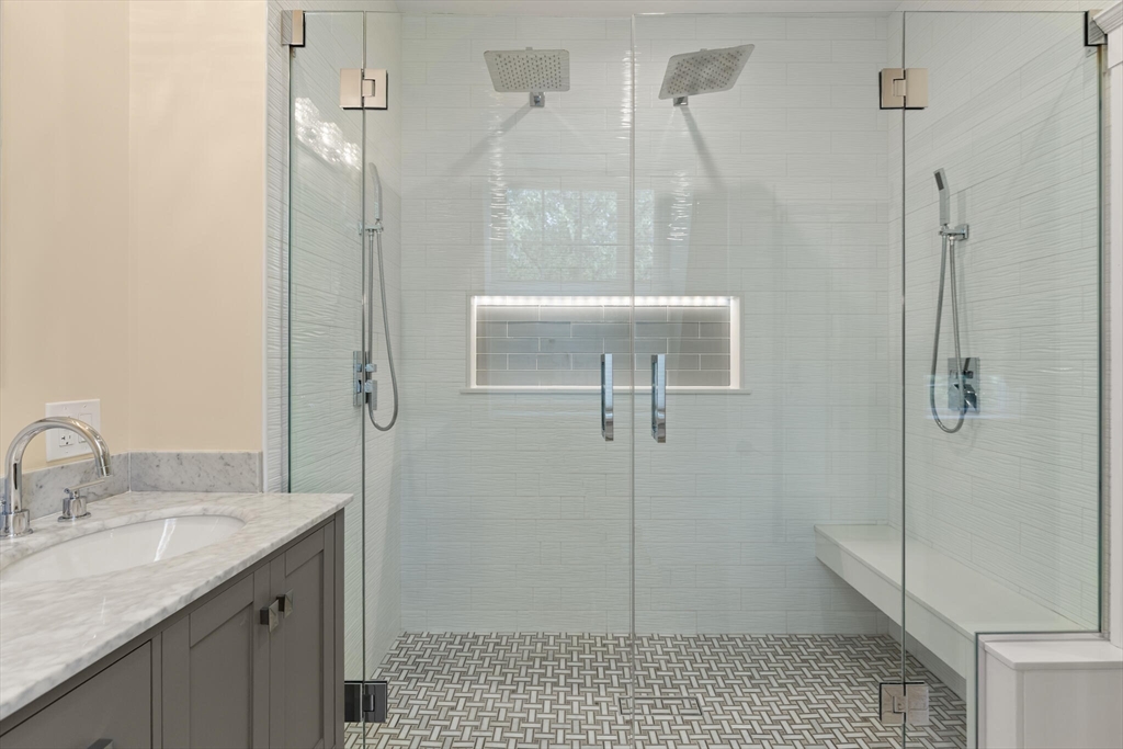 125 Heath Street Somerville, MA 02145 - Photo 24 of 42 a bathroom with a granite countertop sink a toilet and shower