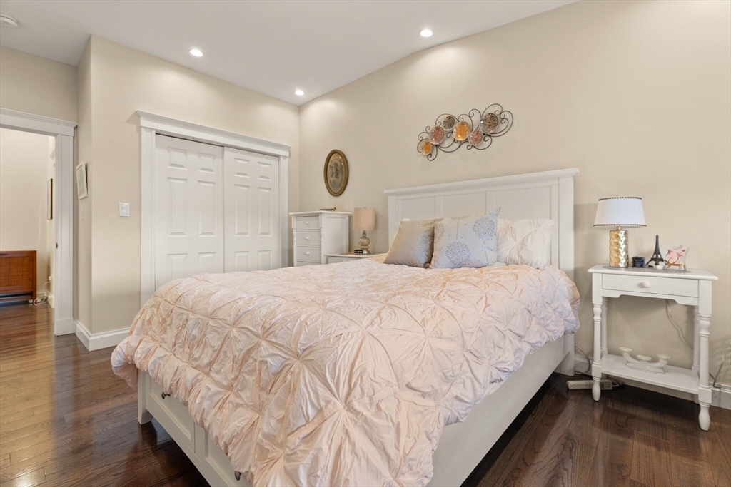 125 Heath Street Somerville, MA 02145 - Photo 28 of 42 a bedroom with bed and a chandelier