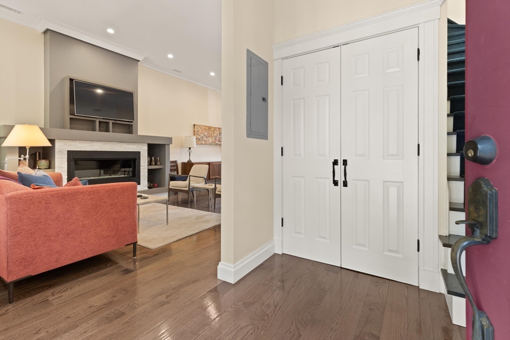 125 Heath Street Somerville, MA 02145 - Photo 3 of 42 a living room with furniture a fireplace and a flat screen tv