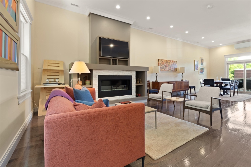 125 Heath Street Somerville, MA 02145 - Photo 4 of 42 a living room with furniture a fireplace and a flat screen tv