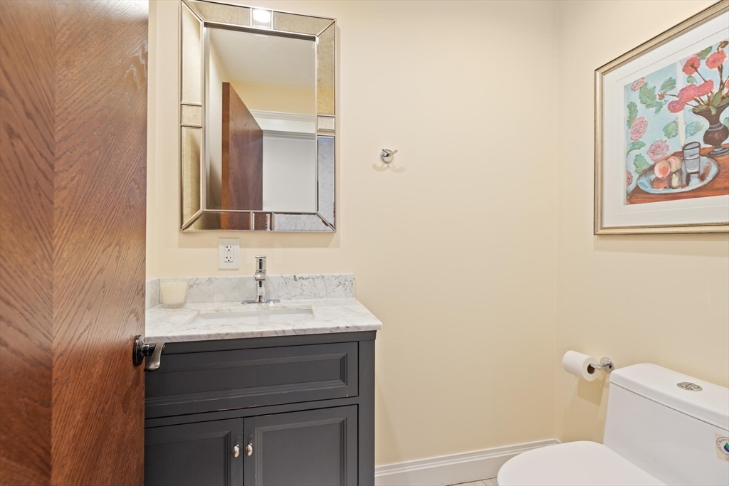 125 Heath Street Somerville, MA 02145 - Photo 8 of 42 a bathroom with a toilet sink and mirror