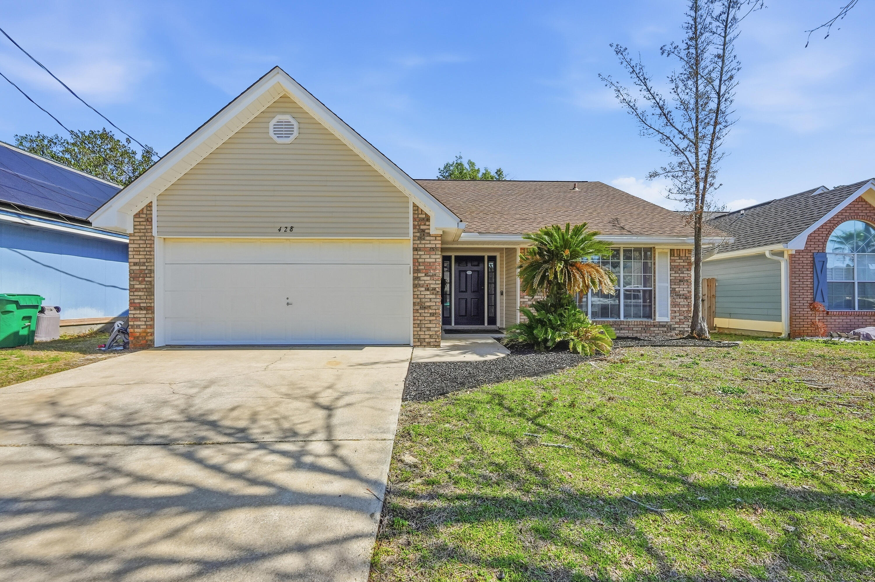 428 Sandy Ridge Circle Mary Esther, FL 32569 - Photo 1 of 44 a front view of a house with a yard and garage