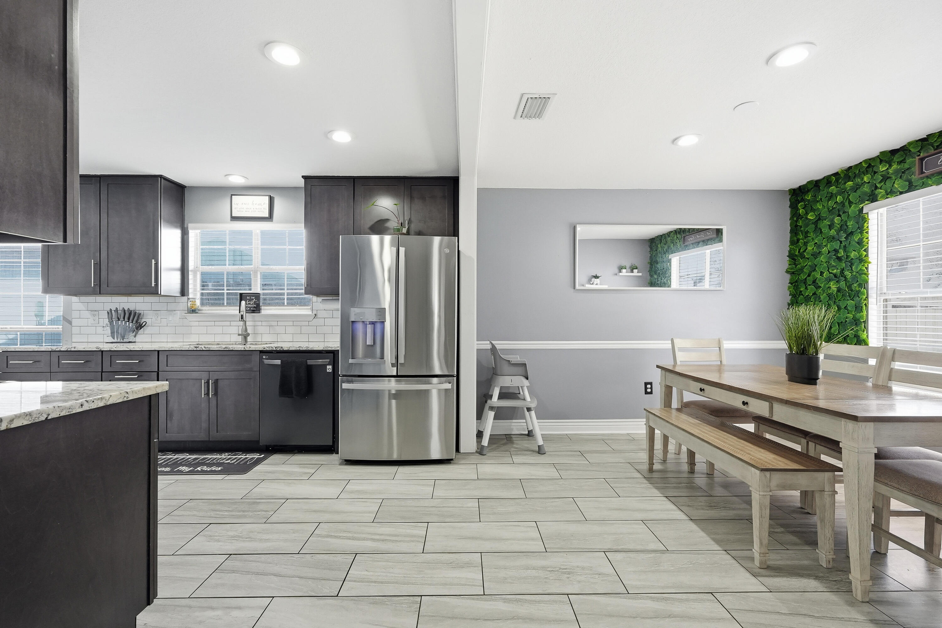 428 Sandy Ridge Circle Mary Esther, FL 32569 - Photo 25 of 44 a kitchen with stainless steel appliances a refrigerator a sink a stove a microwave a dining table and chairs