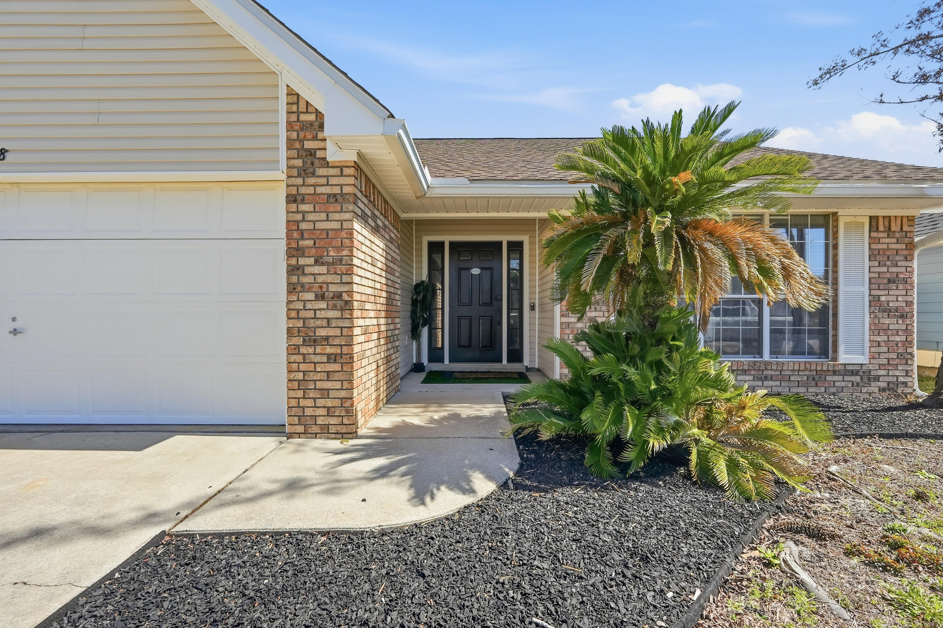 428 Sandy Ridge Circle Mary Esther, FL 32569 - Photo 6 of 44 a couple of potted plants in front of door