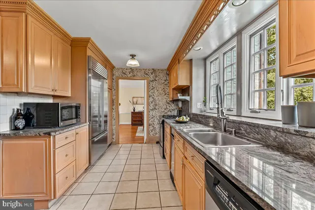 a kitchen with stainless steel appliances a stove a sink and a microwave