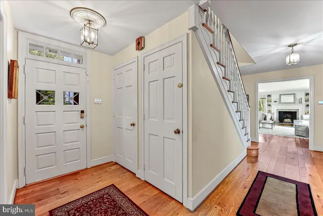 a view of a livingroom with wooden floor and stairs