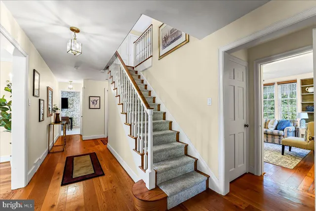a spacious bedroom with a large bed and a chandelier