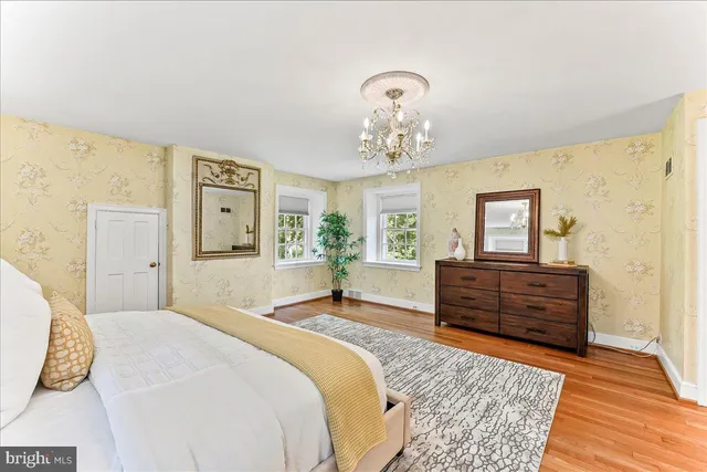 a bathroom with a double vanity sink a mirror and a bathtub