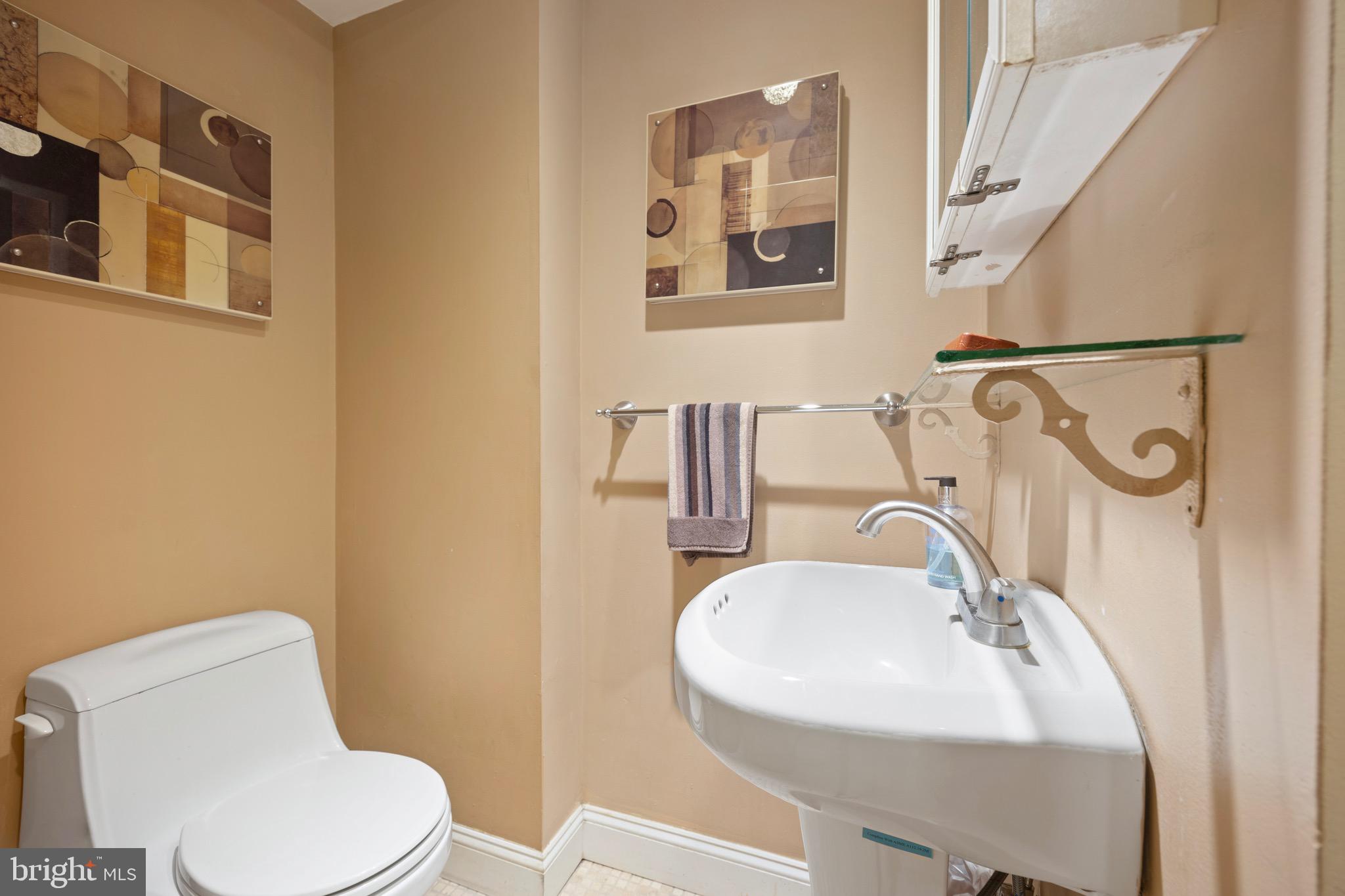 2201 Chestnut Street, Unit 304 Philadelphia, PA 19103 - Photo 14 of 22 a bathroom with a sink mirror and toilet