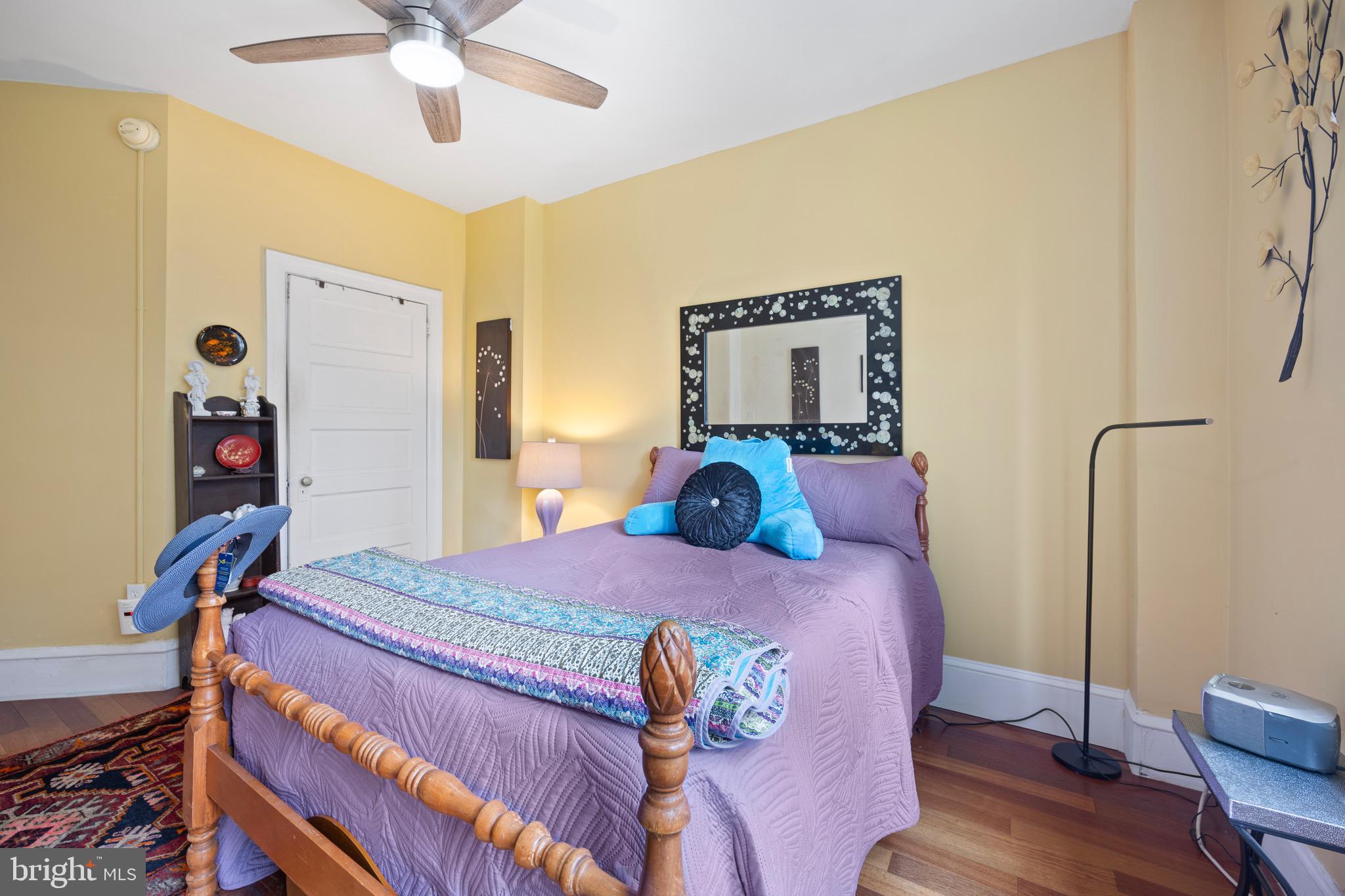 2201 Chestnut Street, Unit 304 Philadelphia, PA 19103 - Photo 18 of 22 a bedroom with a bed and a chandelier