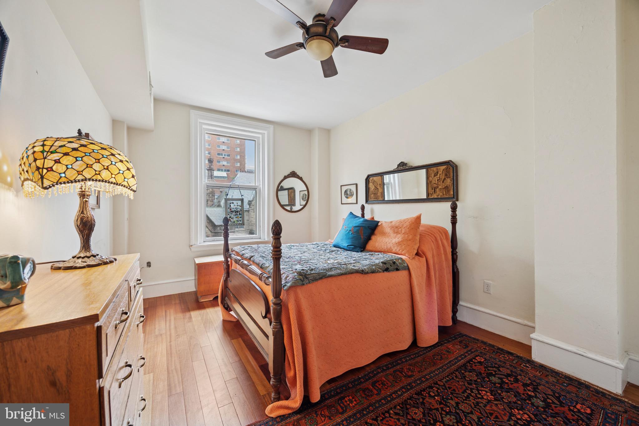 2201 Chestnut Street, Unit 304 Philadelphia, PA 19103 - Photo 19 of 22 a bed room with a bed and a chandelier