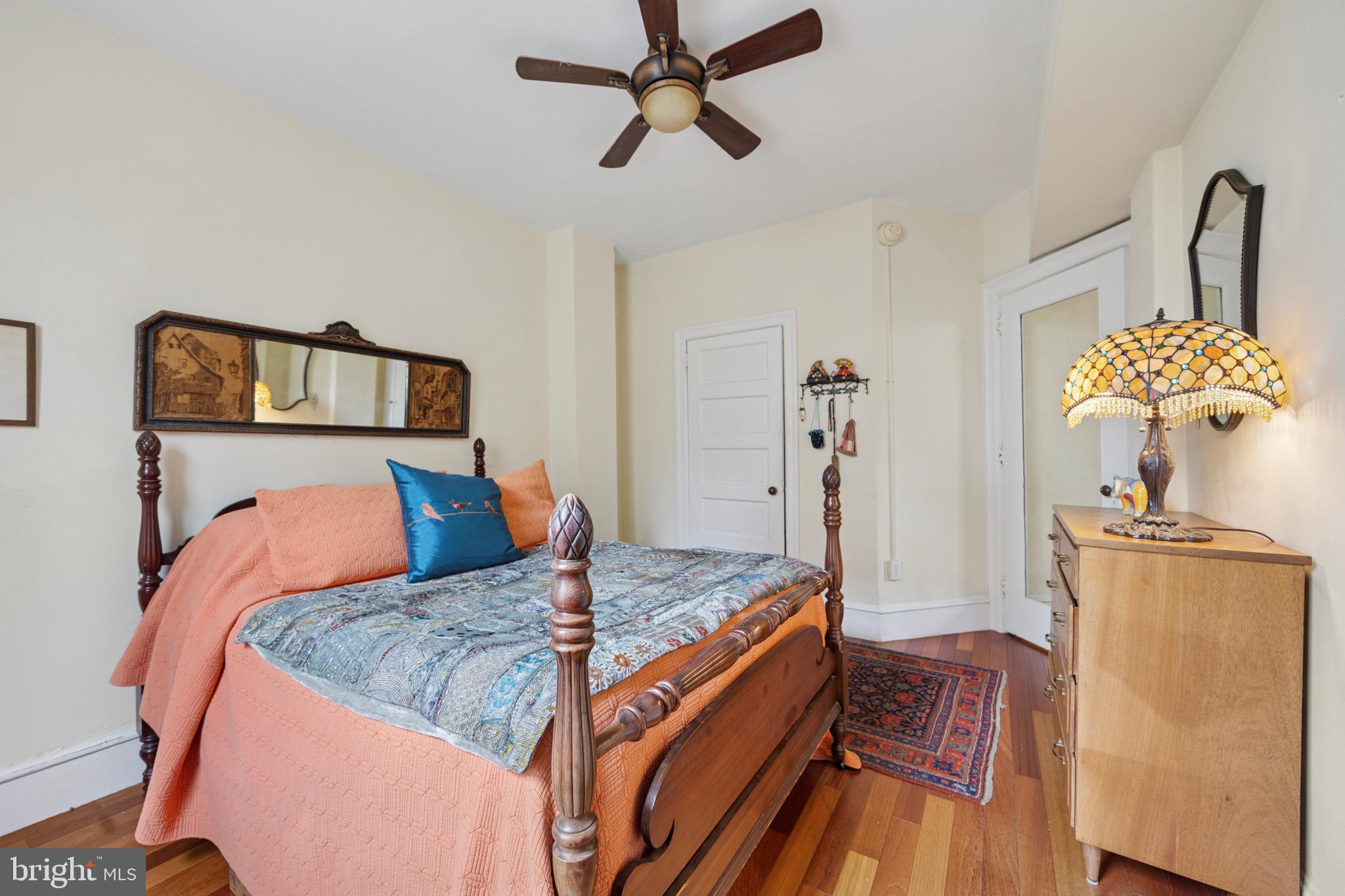 2201 Chestnut Street, Unit 304 Philadelphia, PA 19103 - Photo 20 of 22 a bedroom with a bed and a chandelier