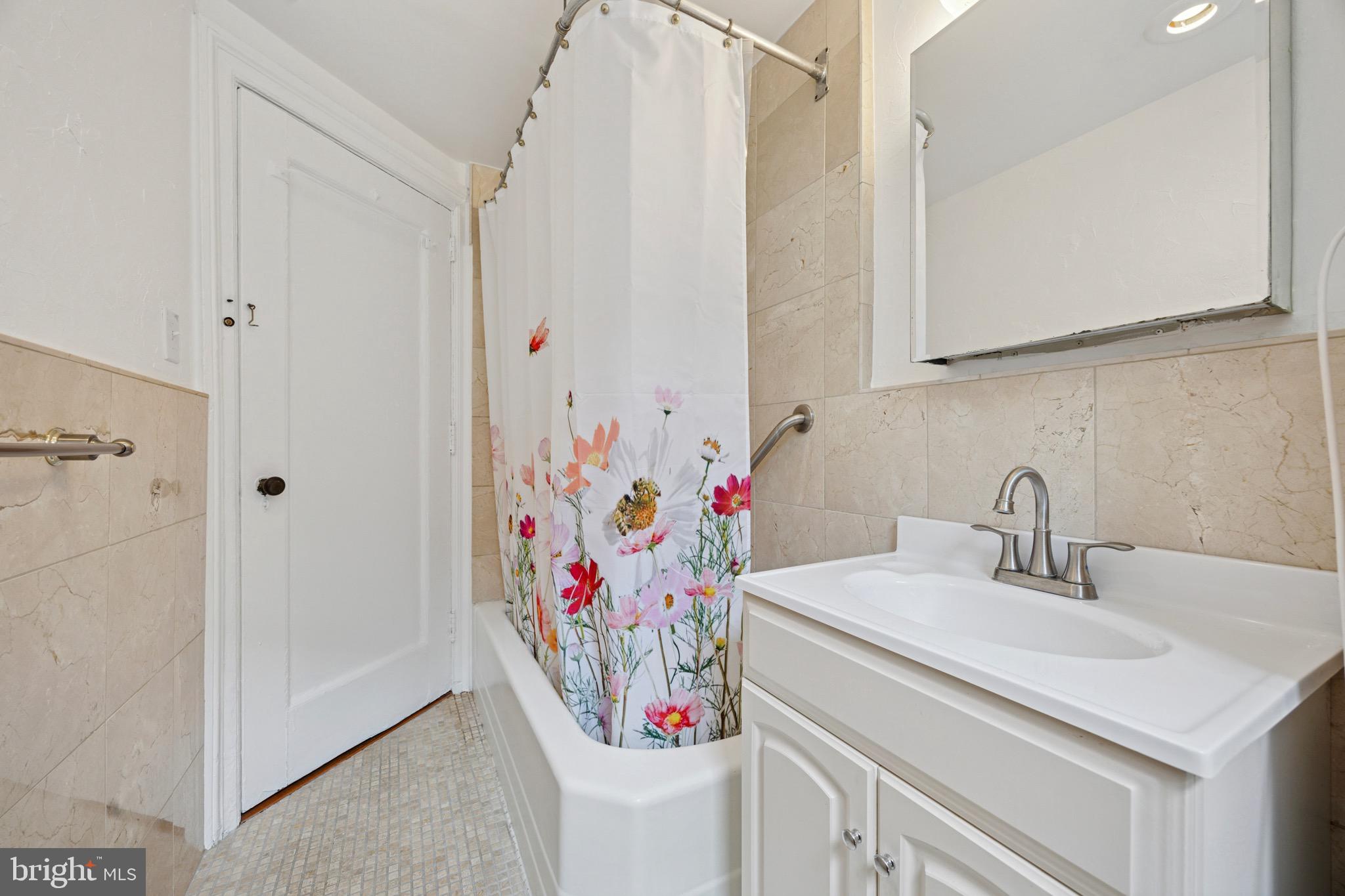 2201 Chestnut Street, Unit 304 Philadelphia, PA 19103 - Photo 22 of 22 a bathroom with a sink and a mirror