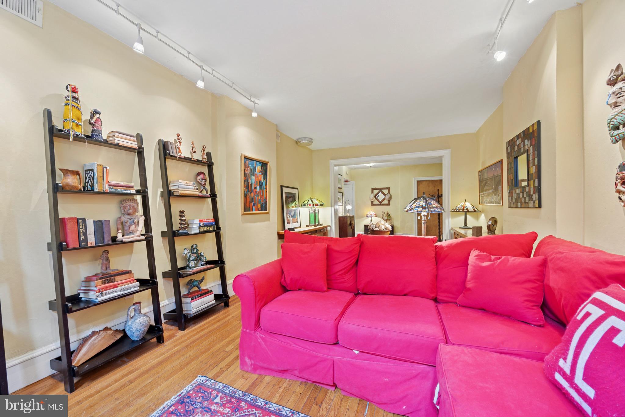 2201 Chestnut Street, Unit 304 Philadelphia, PA 19103 - Photo 9 of 22 a living room with lots of furniture and a book shelf