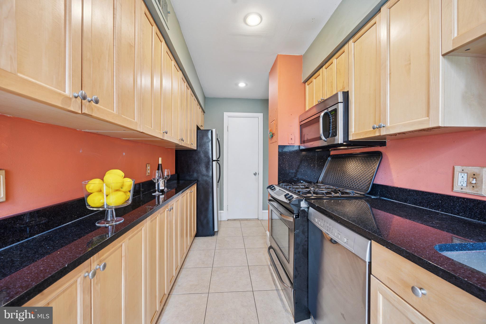 2201 Chestnut Street, Unit 304 Philadelphia, PA 19103 - Photo 10 of 22 a kitchen with stainless steel appliances granite countertop a stove a sink and a refrigerator