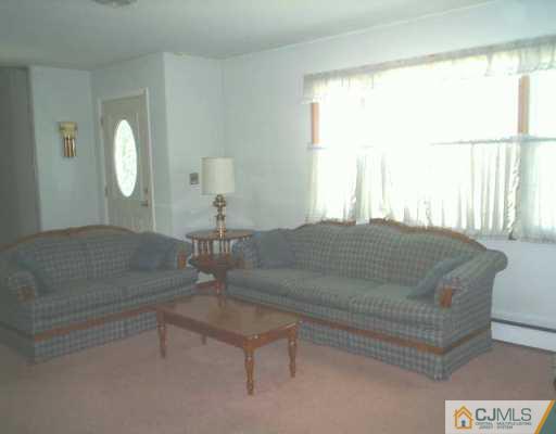 441 Crows Mill Road Fords, NJ 08863 - Photo 5 of 5 a living room with a bed furniture and a large window