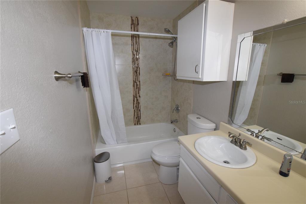 5533 Chrishire Way, Unit F201 Orlando, FL 32822 - Photo 11 of 12 a bathroom with a sink toilet and shower
