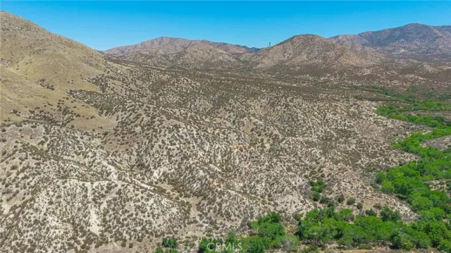 a view of mountain with a field