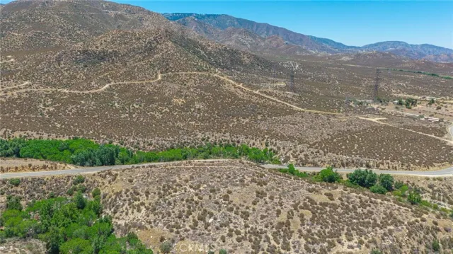 a view of a mountain with a yard