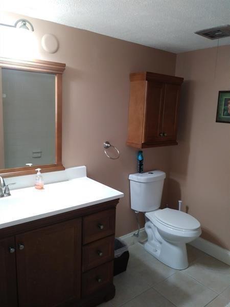100 Golden Isles Drive, Unit 511 Hallandale Beach, FL 33009 - Photo 11 of 20 a bathroom with a toilet a sink and mirror