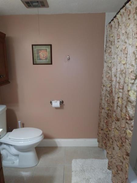100 Golden Isles Drive, Unit 511 Hallandale Beach, FL 33009 - Photo 12 of 20 a white toilet sitting next to a shower curtain