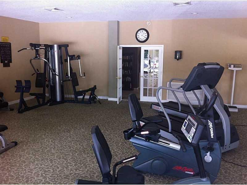 100 Golden Isles Drive, Unit 511 Hallandale Beach, FL 33009 - Photo 18 of 20 a view of a room with gym equipment