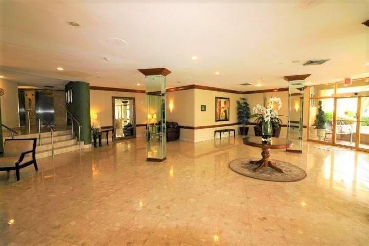 100 Golden Isles Drive, Unit 511 Hallandale Beach, FL 33009 - Photo 20 of 20 a swimming pool with outdoor seating and view of a living room