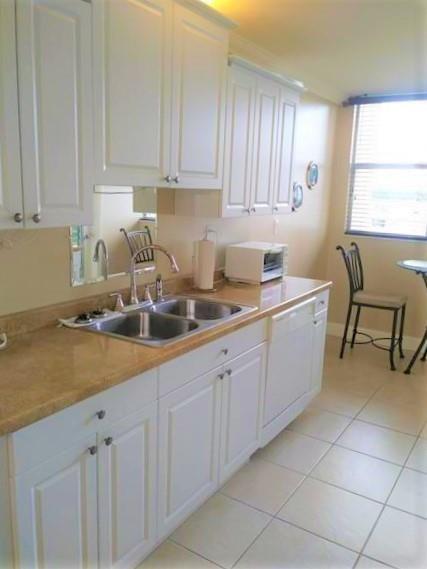 100 Golden Isles Drive, Unit 511 Hallandale Beach, FL 33009 - Photo 3 of 20 a kitchen with a sink and cabinets
