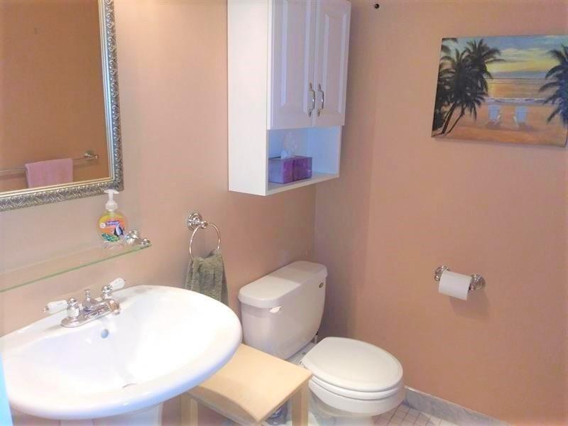 100 Golden Isles Drive, Unit 511 Hallandale Beach, FL 33009 - Photo 9 of 20 a bathroom with a toilet a sink and mirror