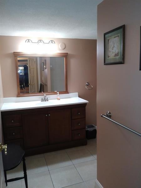 100 Golden Isles Drive, Unit 511 Hallandale Beach, FL 33009 - Photo 10 of 20 a bathroom with a sink vanity and a mirror