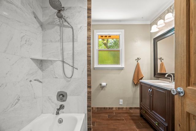 a bathroom with a bathtub a sink and a shower