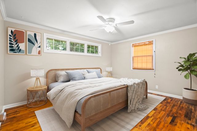 a bedroom with a bed and a potted plant