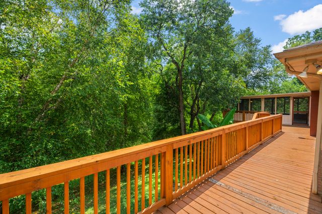 a view of balcony with deck and wooden floor