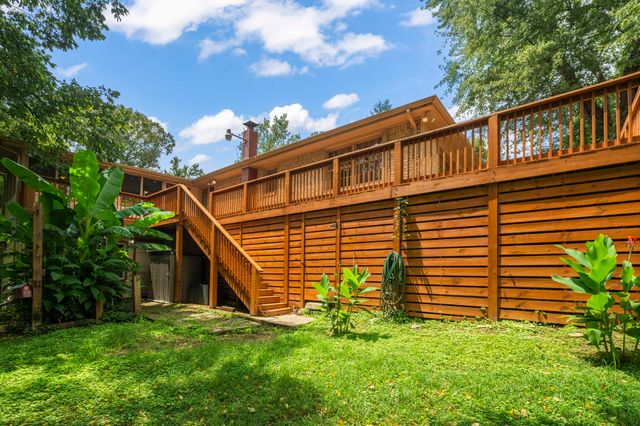 a view of a house with a yard and a garden