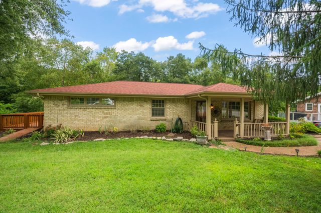 a view of a house with garden and sitting area