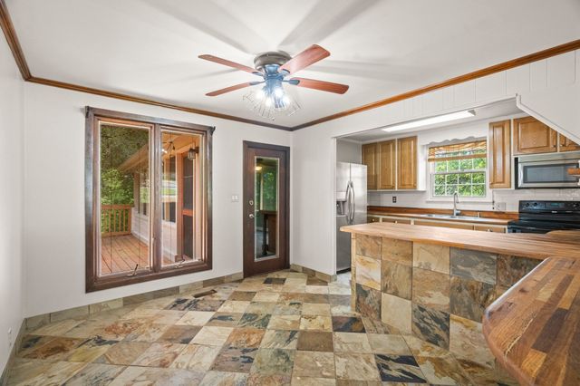 a view of a kitchen with a sink and cabinets