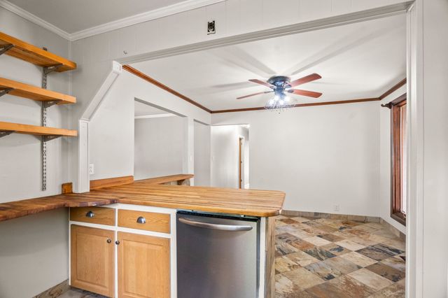 a view of a kitchen with a sink and a refrigerator