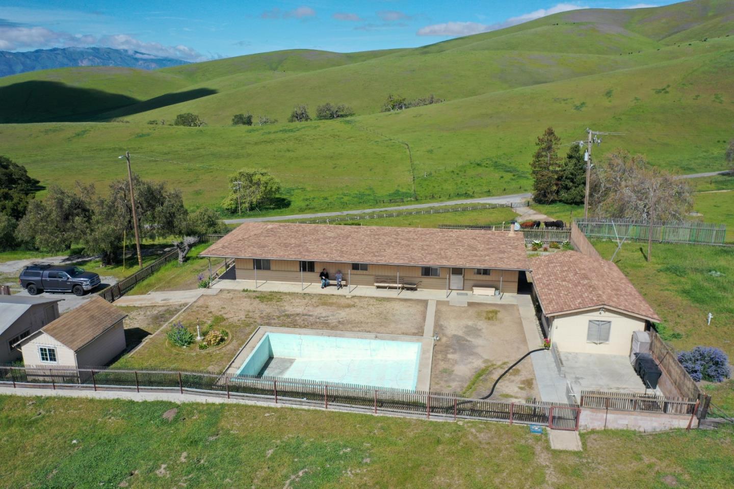 an aerial view of a house with yard swimming pool and mountain view