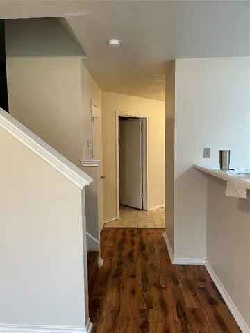 a view of walk in closet with wooden floor