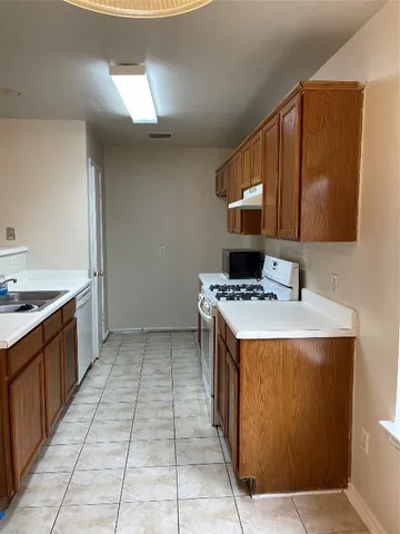 a kitchen with a sink stove and cabinets