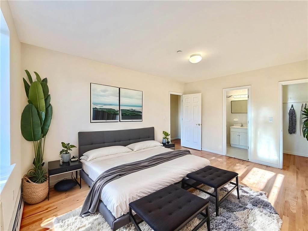 511 68th Street, Unit 2A Brooklyn, NY 11220 - Photo 11 of 19 a bedroom with a bed a couch and chandelier