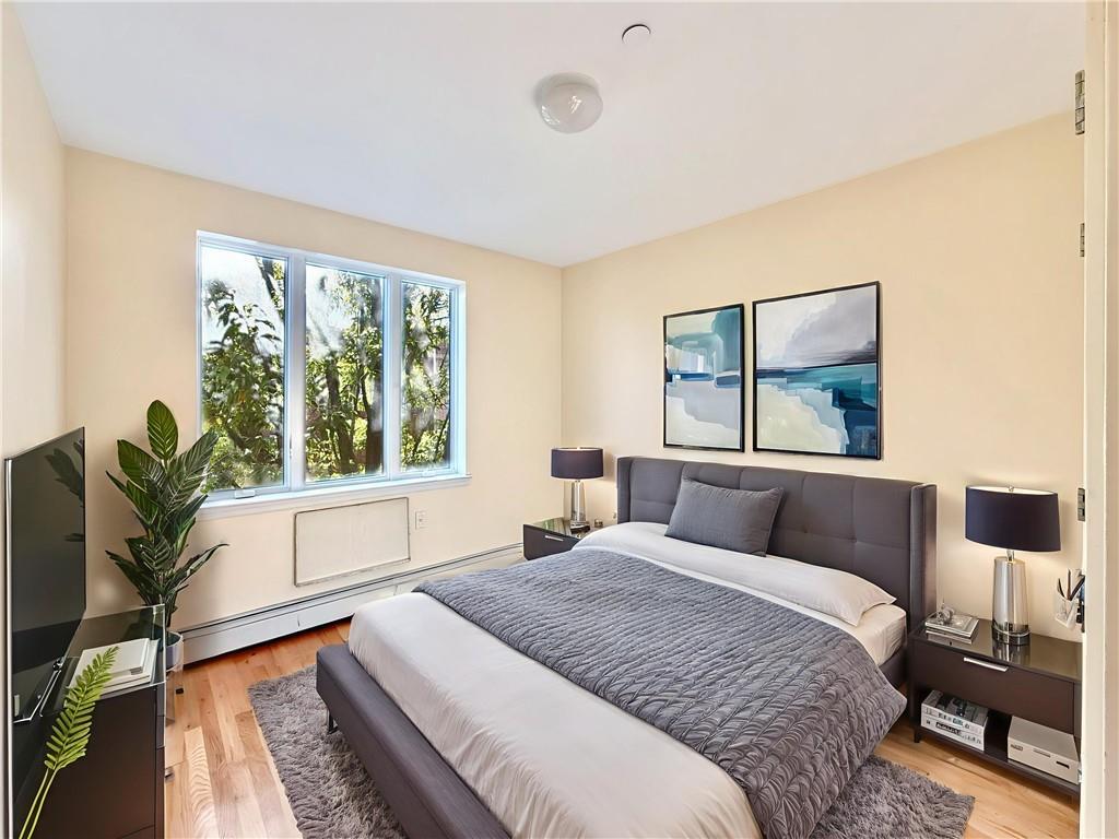 511 68th Street, Unit 2A Brooklyn, NY 11220 - Photo 15 of 19 a bedroom with a bed and a large window