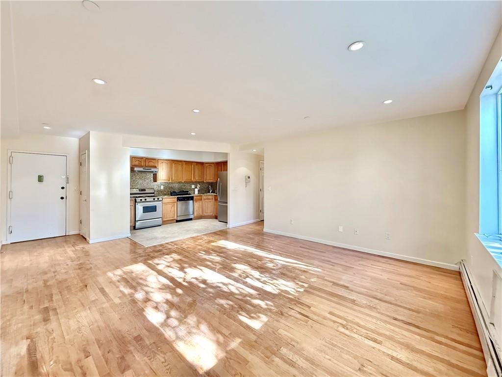 511 68th Street, Unit 2A Brooklyn, NY 11220 - Photo 3 of 19 a view of a big room with wooden floor and a window