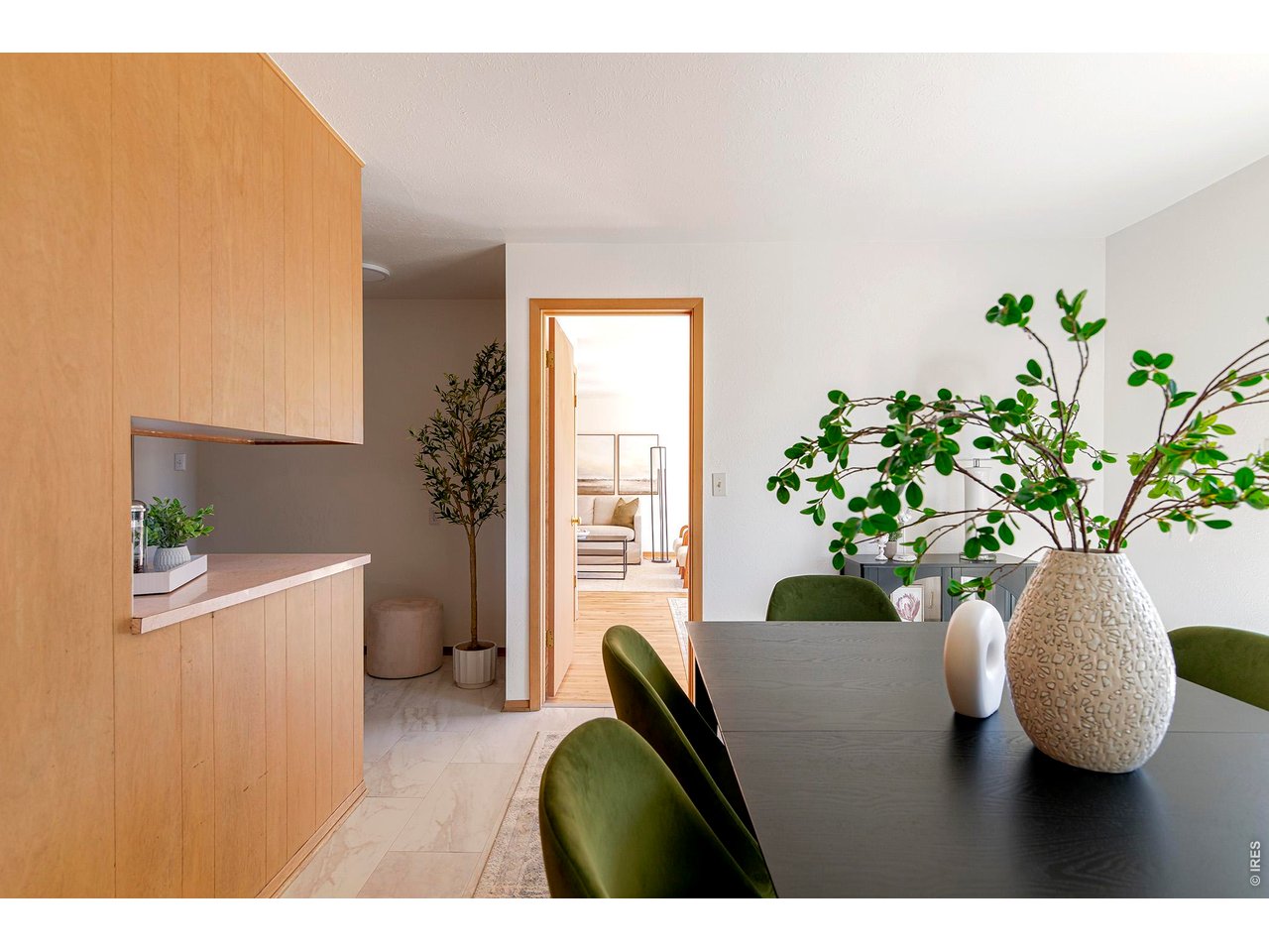 2410 Grape Avenue Boulder, CO 80304 - Photo 16 of 50 Warm wood cabinetry and soft tile flooring create a seamless transition from kitchen to dining, maintaining the home's cohesive mid-century character. An open doorway