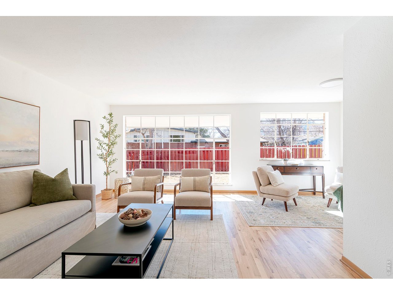 2410 Grape Avenue Boulder, CO 80304 - Photo 2 of 50 A wall of oversized grid-pane windows fills the room with natural light, creating a bright, open atmosphere and a seamless connection to the backyard. Warm refinished hardwood floors run throughout the home